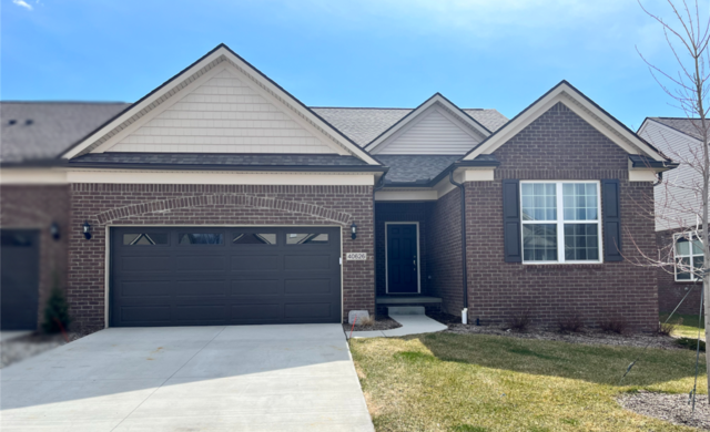 view of front of house with a front yard and a garage