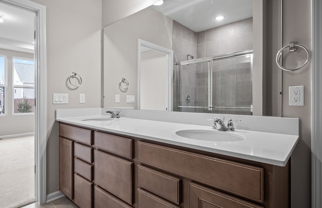 bathroom featuring vanity and a shower with door