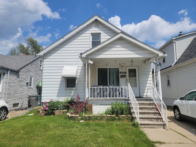 bungalow featuring a front lawn and covered porch