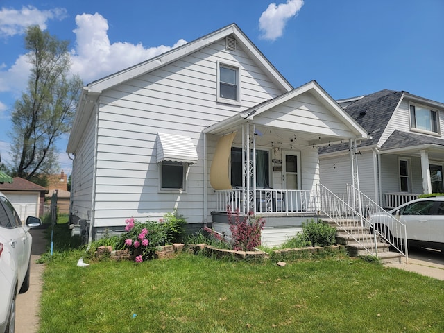 bungalow-style home with a porch and a front lawn