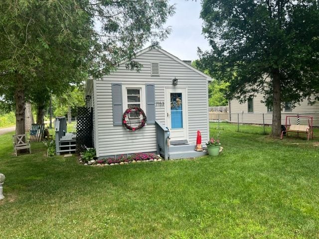 back of house with a yard and a wooden deck