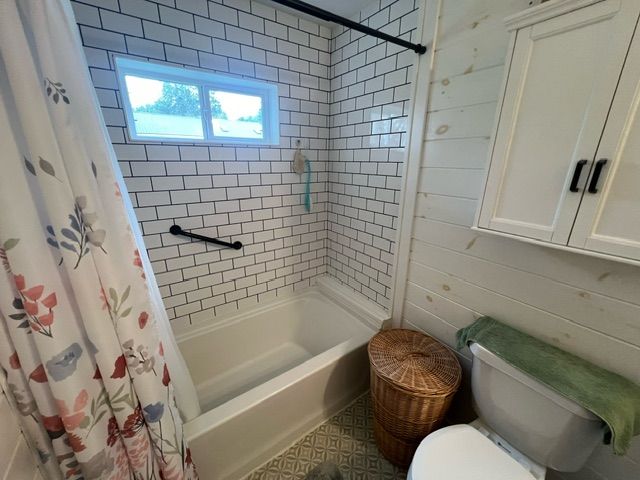 7153 Cedar Rd, Lexington, MI 48450 - bathroom featuring shower / bath combo with shower curtain and toilet