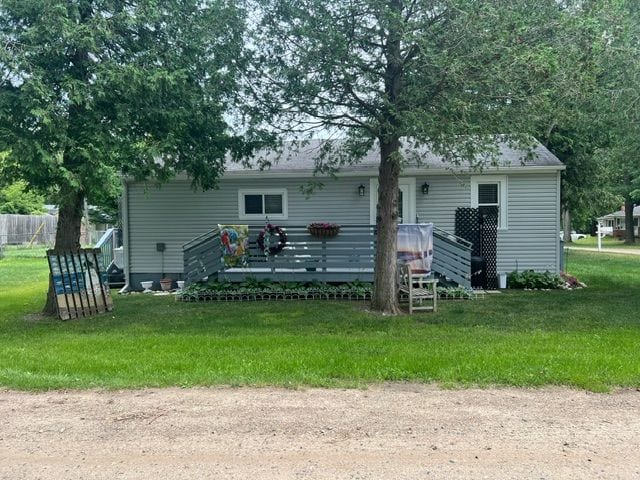 rear view of property with a lawn and a wooden deck