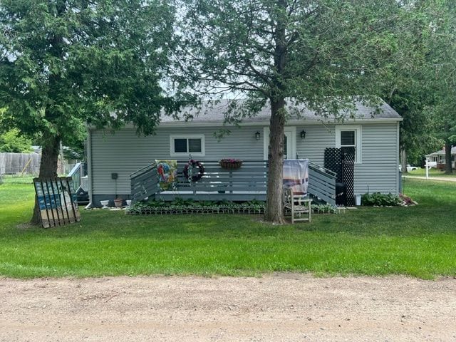7153 Cedar Rd, Lexington, MI 48450 - back of house featuring a yard, a deck, and fence