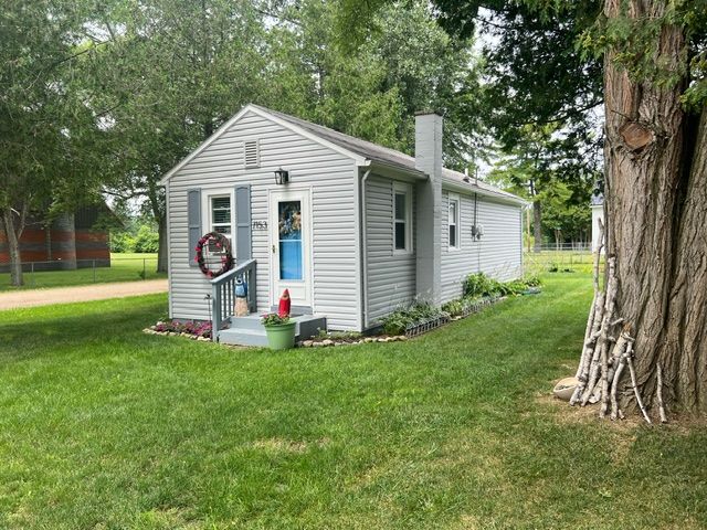 view of outbuilding featuring a lawn