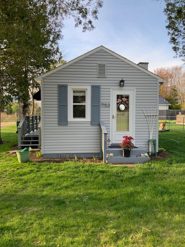 7153 Cedar Rd, Lexington, MI 48450 - view of front of house featuring fence and a front lawn