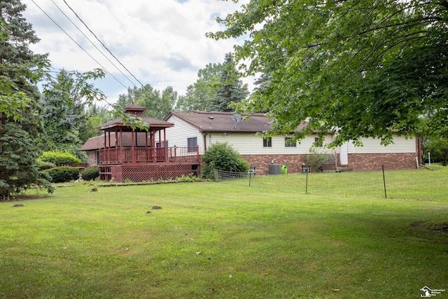 view of yard with a gazebo, central AC, and a deck