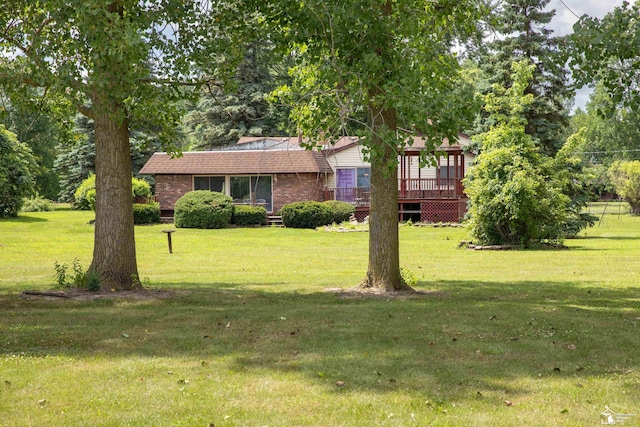 28237 W Huron River Dr, Huron, MI 48134 - view of front of home featuring brick siding, a front yard, and a wooden deck