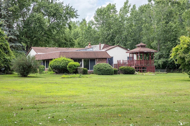 exterior space featuring a gazebo and a lawn