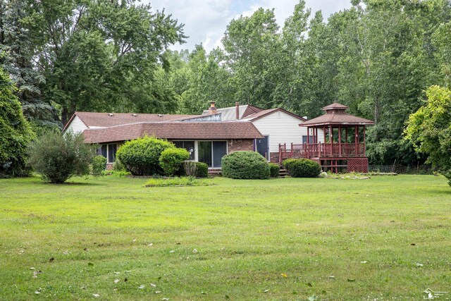 28237 W Huron River Dr, Huron, MI 48134 - ranch-style home featuring a gazebo, a front yard, a shingled roof, and a chimney