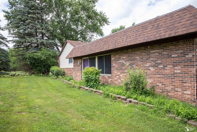 view of side of home featuring a yard