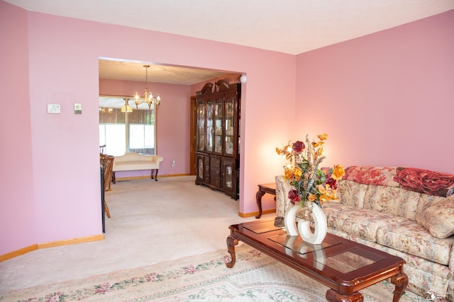 living room featuring carpet and an inviting chandelier