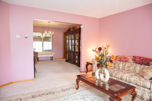 28237 W Huron River Dr, Huron, MI 48134 - living area featuring light carpet, baseboards, and a chandelier