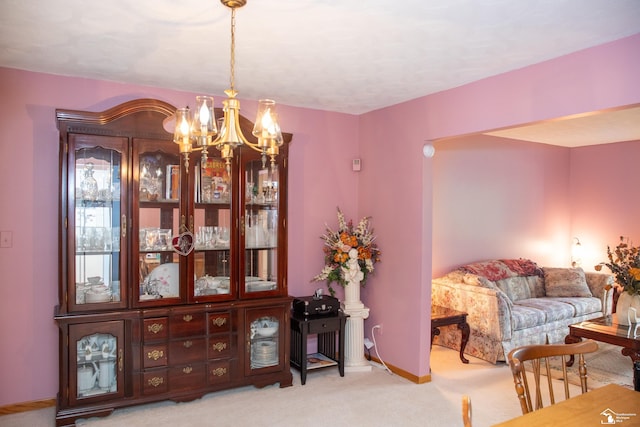 sitting room with light colored carpet and a chandelier