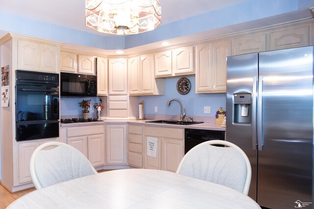 28237 W Huron River Dr, Huron, MI 48134 - kitchen featuring black appliances, a warming drawer, a sink, a chandelier, and light countertops