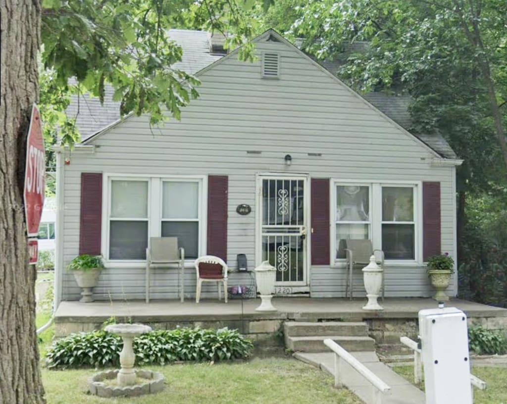 12201 Stout St, Detroit, MI 48228 - view of front facade with a porch and a front lawn