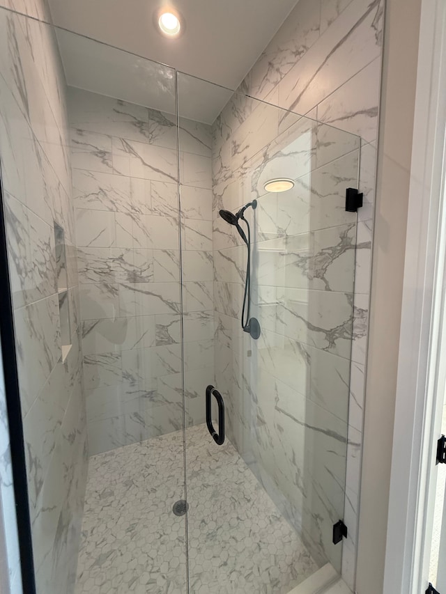 full bath featuring a marble finish shower and recessed lighting