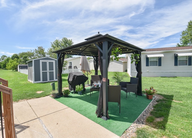 view of patio / terrace featuring a gazebo, area for grilling, and a storage shed