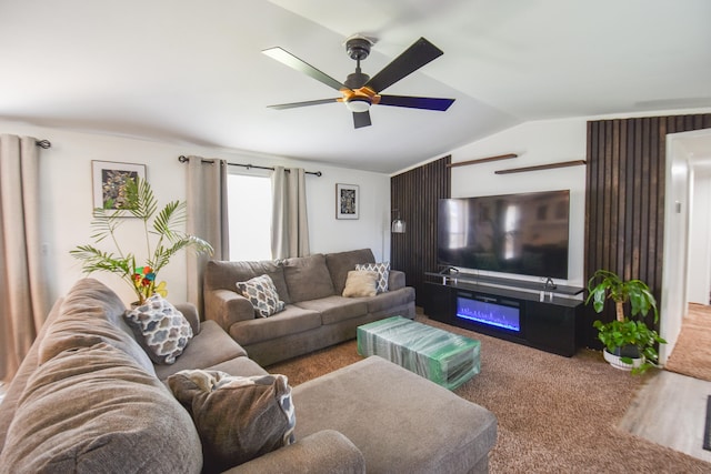 carpeted living room featuring ceiling fan and lofted ceiling