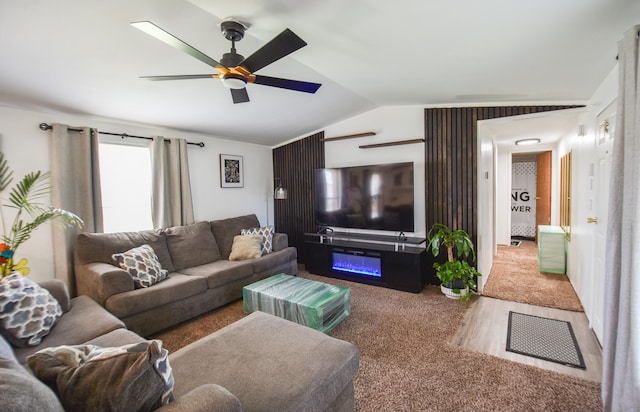 living room with carpet flooring, ceiling fan, and lofted ceiling