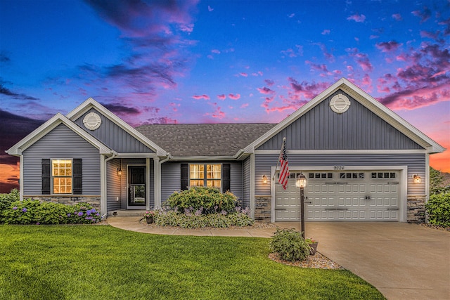 view of front of house with a yard and a garage