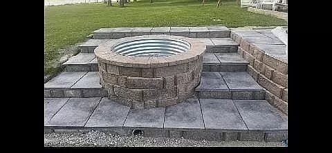 exterior details featuring an outdoor fire pit