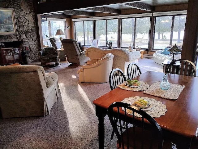 dining space with beam ceiling, carpet floors, and a baseboard radiator