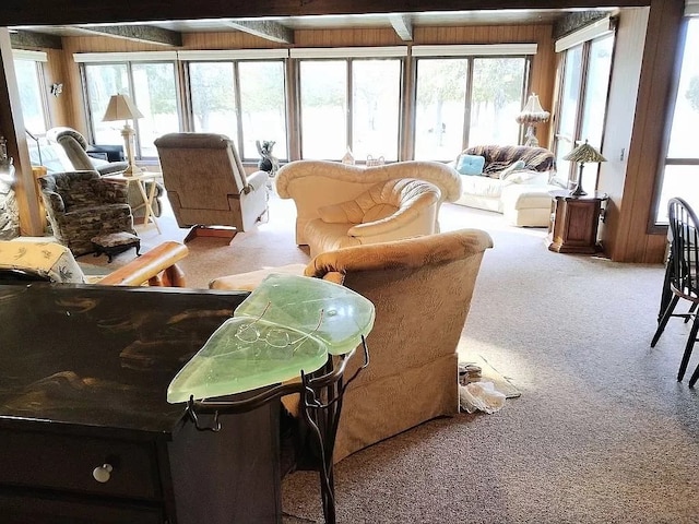 sunroom with plenty of natural light and beamed ceiling