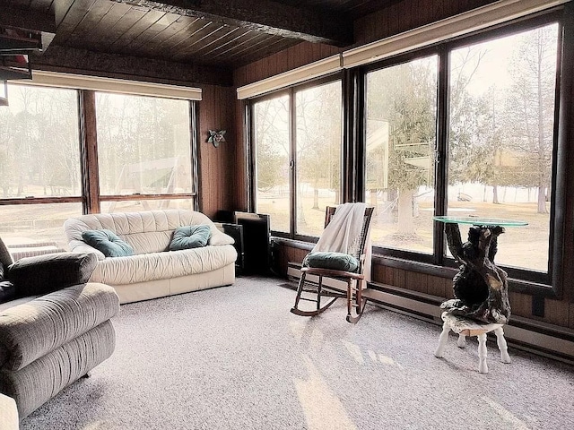 sunroom with plenty of natural light, beamed ceiling, and wooden ceiling