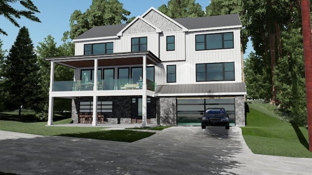 view of front of home with board and batten siding, a front yard, stone siding, and concrete driveway