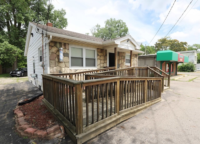 view of front facade with a wooden deck