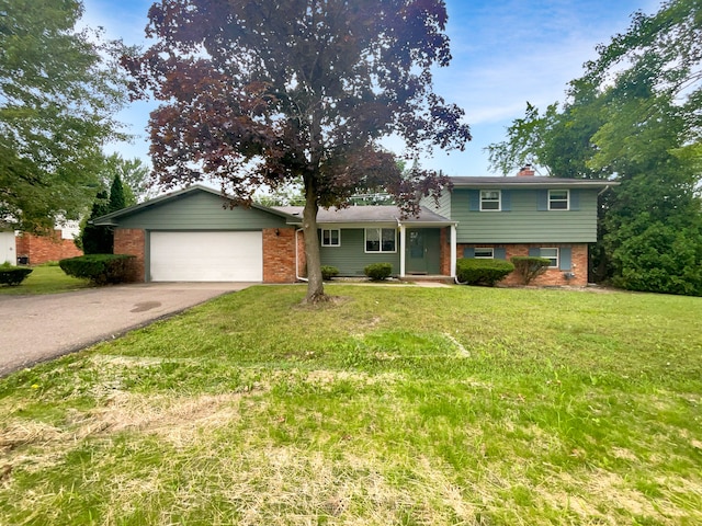 tri-level home with a front yard and a garage