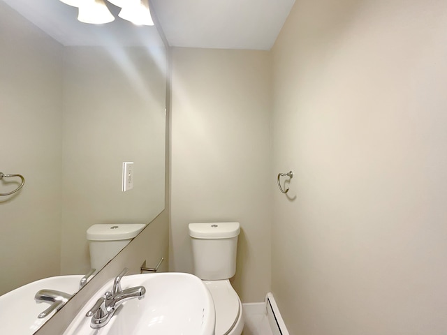 bathroom with baseboard heating and toilet