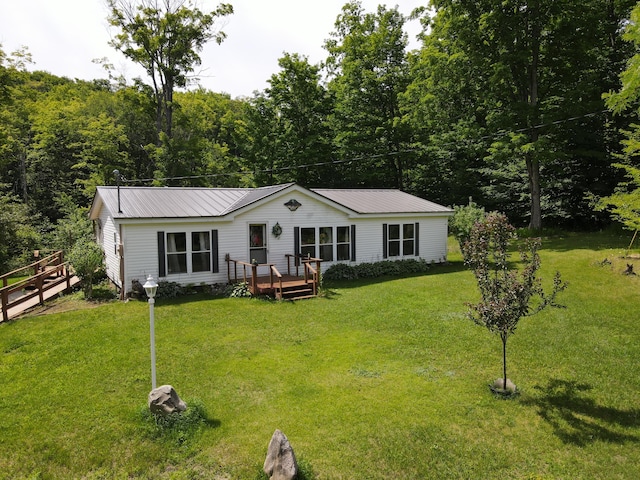 2802 Coulter Creek Trl, Central Lake, MI 49622 - view of front of property featuring a front yard and a deck