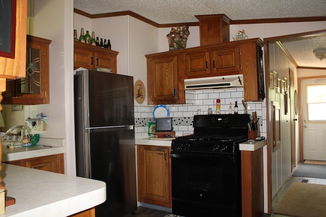 2802 Coulter Creek Trl, Central Lake, MI 49622 - kitchen featuring stainless steel fridge, black range with gas cooktop, vaulted ceiling, decorative backsplash, and ornamental molding