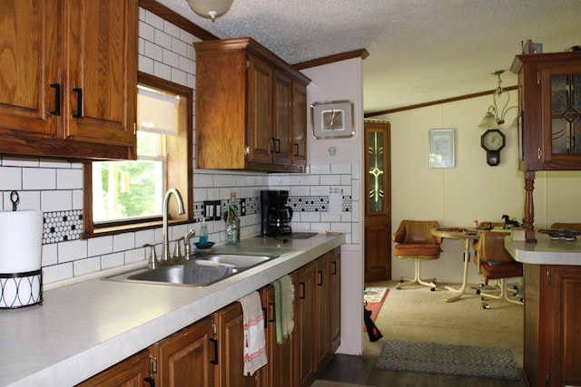 2802 Coulter Creek Trl, Central Lake, MI 49622 - kitchen with backsplash, a textured ceiling, vaulted ceiling, crown molding, and sink