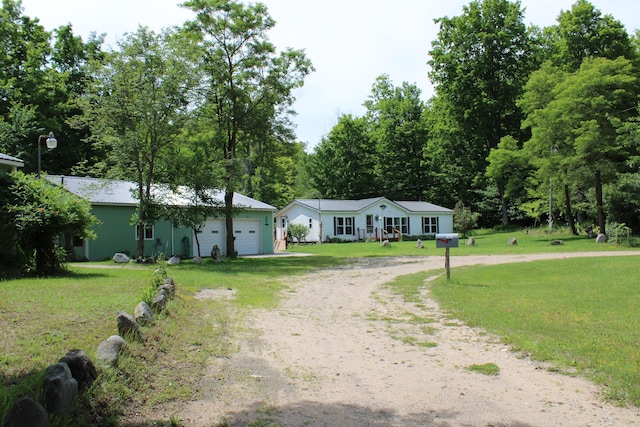 2802 Coulter Creek Trl, Central Lake, MI 49622 - ranch-style home featuring a garage and a front lawn