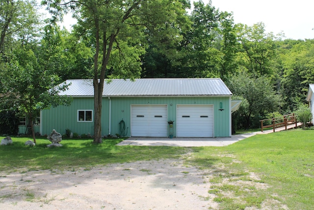 2802 Coulter Creek Trl, Central Lake, MI 49622 - garage featuring a yard