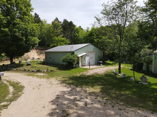 2802 Coulter Creek Trl, Central Lake, MI 49622 - exterior space featuring an outdoor structure and a garage