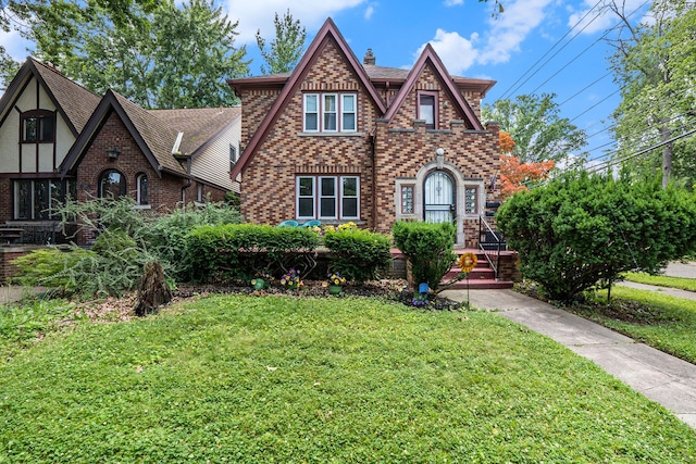 tudor house featuring a front lawn