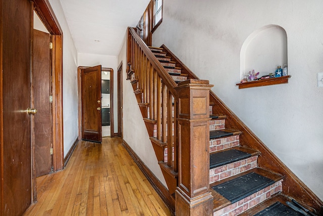 staircase featuring wood-type flooring