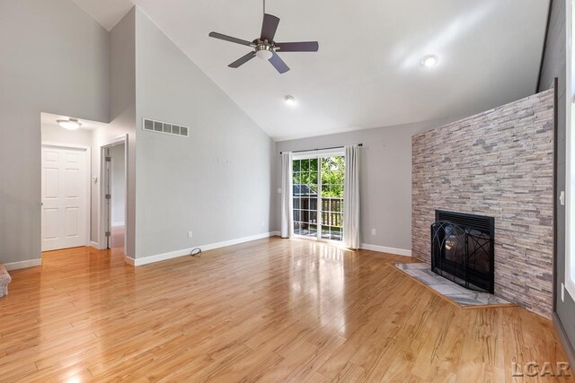 12171 Grandview Dr, Jerome, MI 49249 - unfurnished living room with high vaulted ceiling, a fireplace, a ceiling fan, light wood finished floors, and baseboards