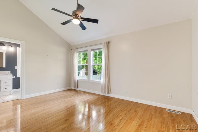 spare room with ceiling fan, high vaulted ceiling, and light hardwood / wood-style floors