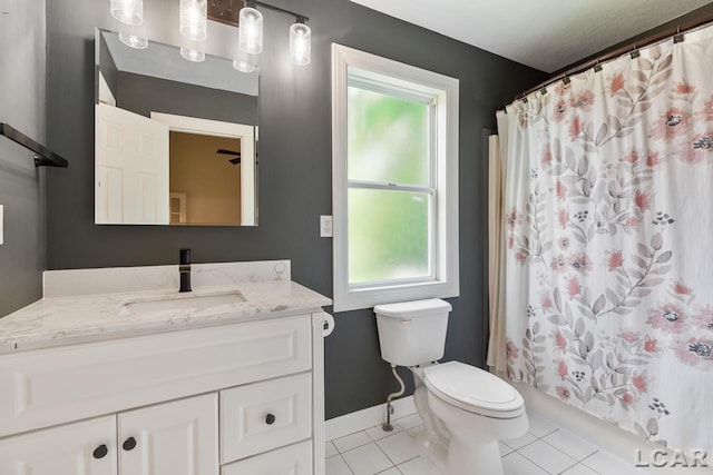 full bathroom featuring tile patterned floors, shower / bathtub combination with curtain, vanity, and toilet