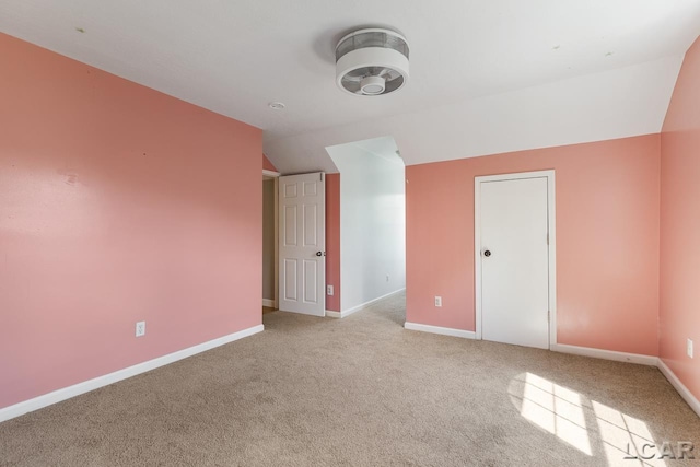 bonus room featuring light carpet and vaulted ceiling