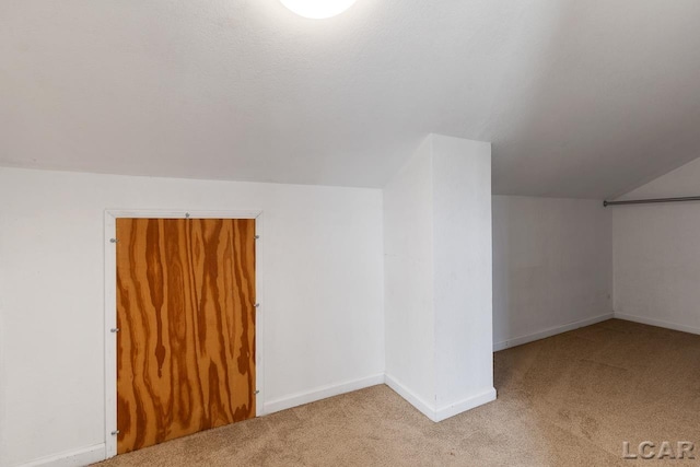 bonus room featuring light colored carpet and lofted ceiling