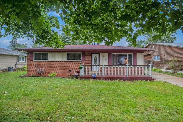 ranch-style house with central air condition unit and a front yard