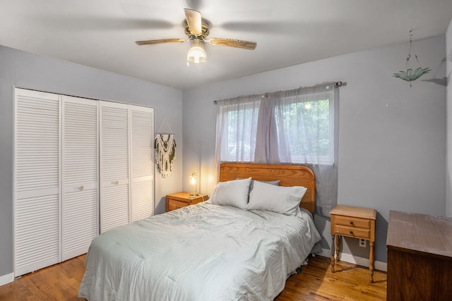 bedroom with ceiling fan, a closet, and light hardwood / wood-style floors