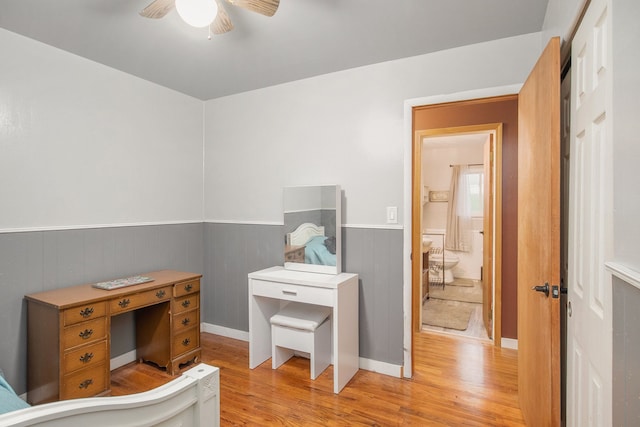 bathroom with ceiling fan and hardwood / wood-style flooring