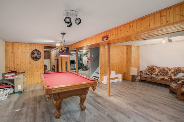 recreation room with hardwood / wood-style floors, wood walls, and billiards